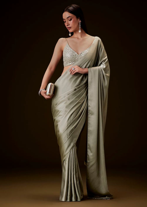 Mint Green Saree With Tassel Embellished Pallu And Deep V Neck Sleeveless Blouse